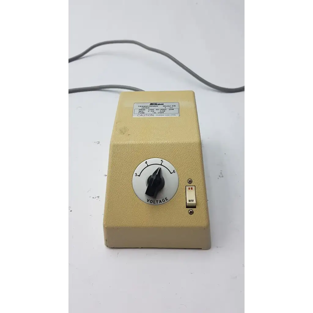 Beige genuine Nikon transformer xn made in Japan with black voltage dial and red-on-white toggle switch