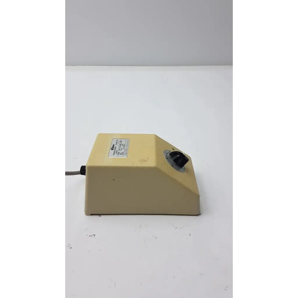 Beige plastic lab mixer with black rotary knob and label on genuine nikon transformer xn made in japan