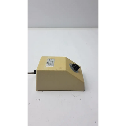 Beige plastic lab mixer with black rotary knob and label on genuine nikon transformer xn made in japan