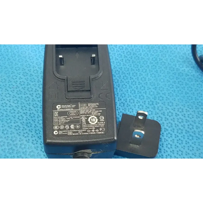 Black plastic gt-41052-1509 adapter charger power adapter back side with detachable uk-style plug and regulatory markings