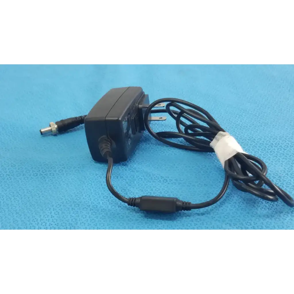 Black plastic gt-41052-1509 adapter charger with coiled power cord and white tape wrap for power adapter use