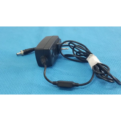 Black plastic gt-41052-1509 adapter charger with coiled power cord and white tape wrap for power adapter use