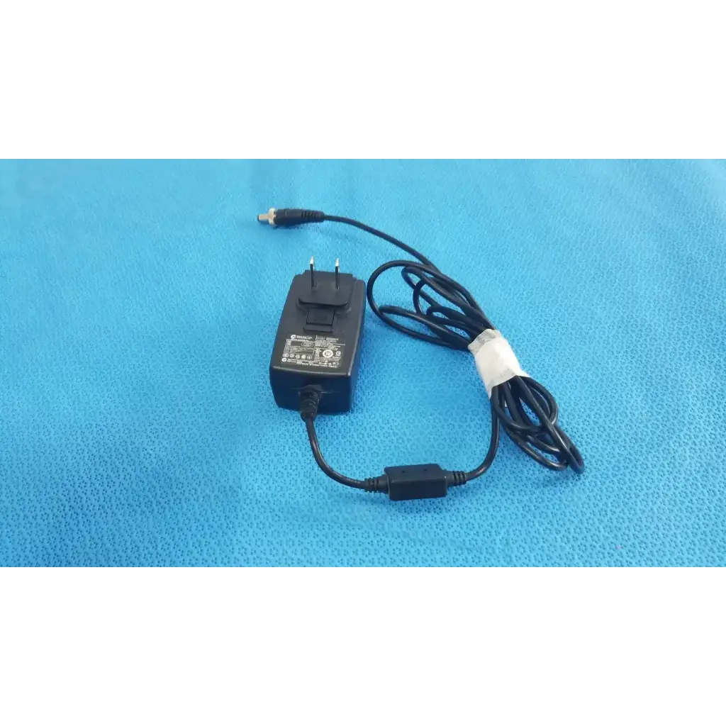 Black plastic globtek gt-41052-1509 adapter charger with coiled power cord and white band securing the cable