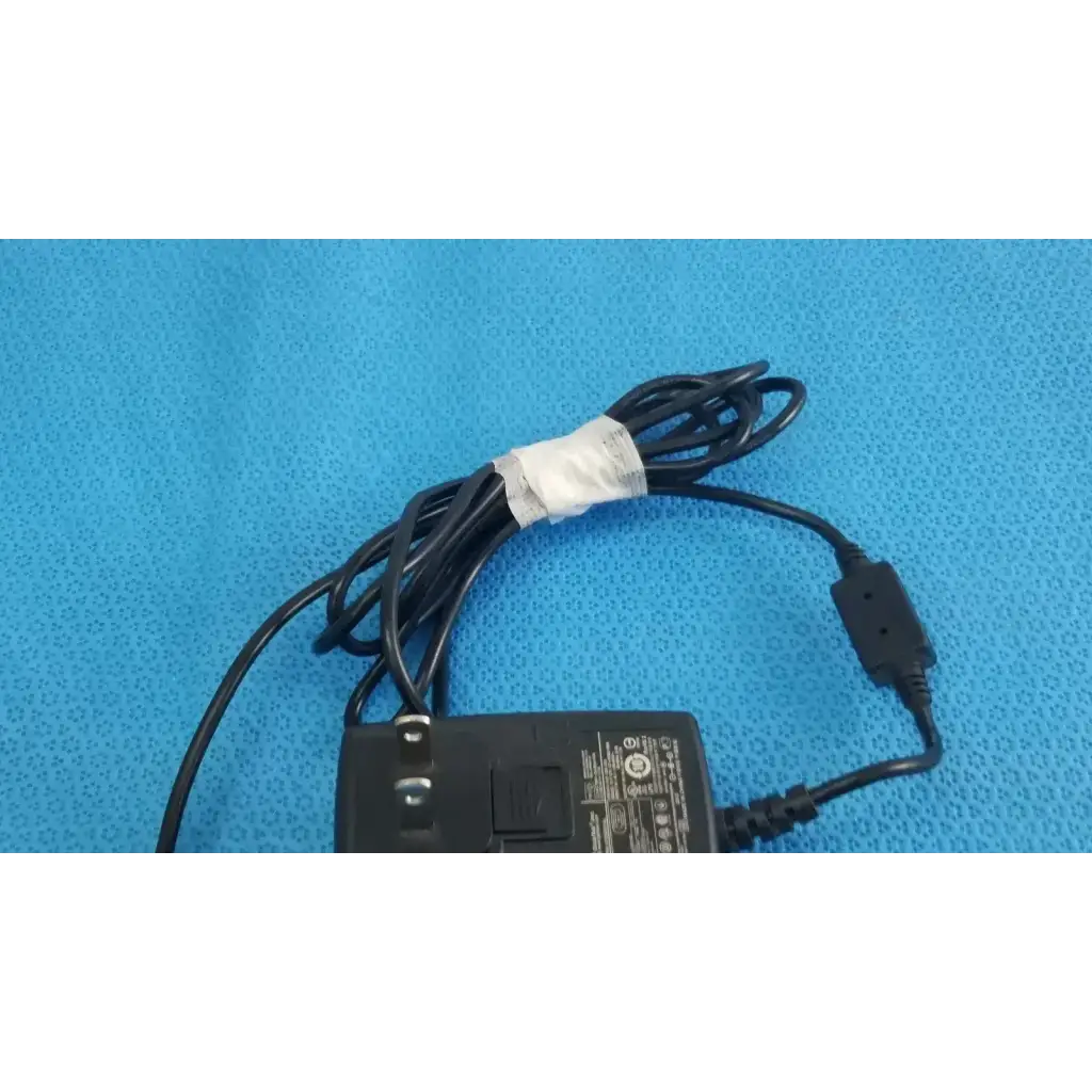 Black plastic globtek gt-41052-1509 adapter charger with coiled cable and white tape wrap on cord power adapter