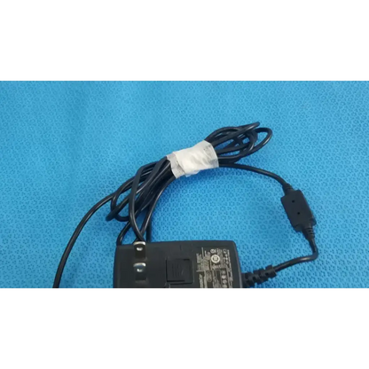Black plastic globtek gt-41052-1509 adapter charger with coiled cable and white tape wrap on cord power adapter