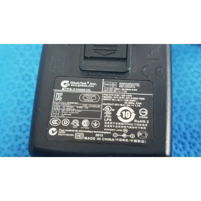 Black plastic power adapter charger gt-41052-1509 with technical specifications label and certification marks on the back side