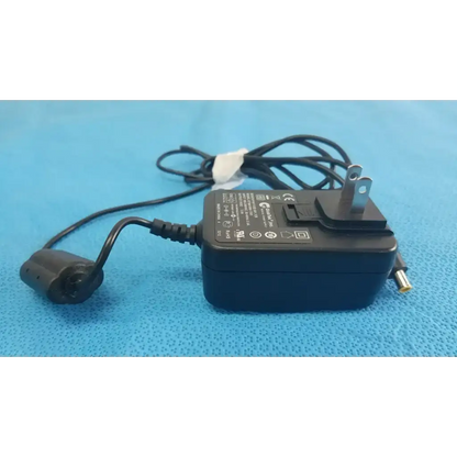 Black plastic globtek gtm41060-1505 medical power supply with coiled power cord and two-prong plug for medical power