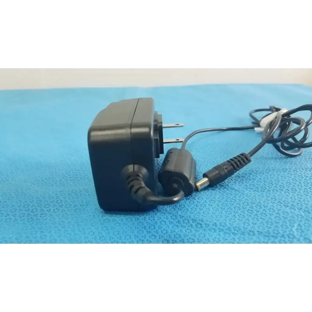Black plastic globtek gtm41060-1505 medical power supply with coiled cord and cylindrical connector for medical power