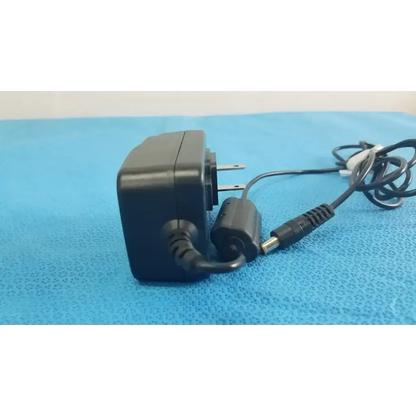 Black plastic globtek gtm41060-1505 medical power supply with coiled cord and cylindrical connector for medical power