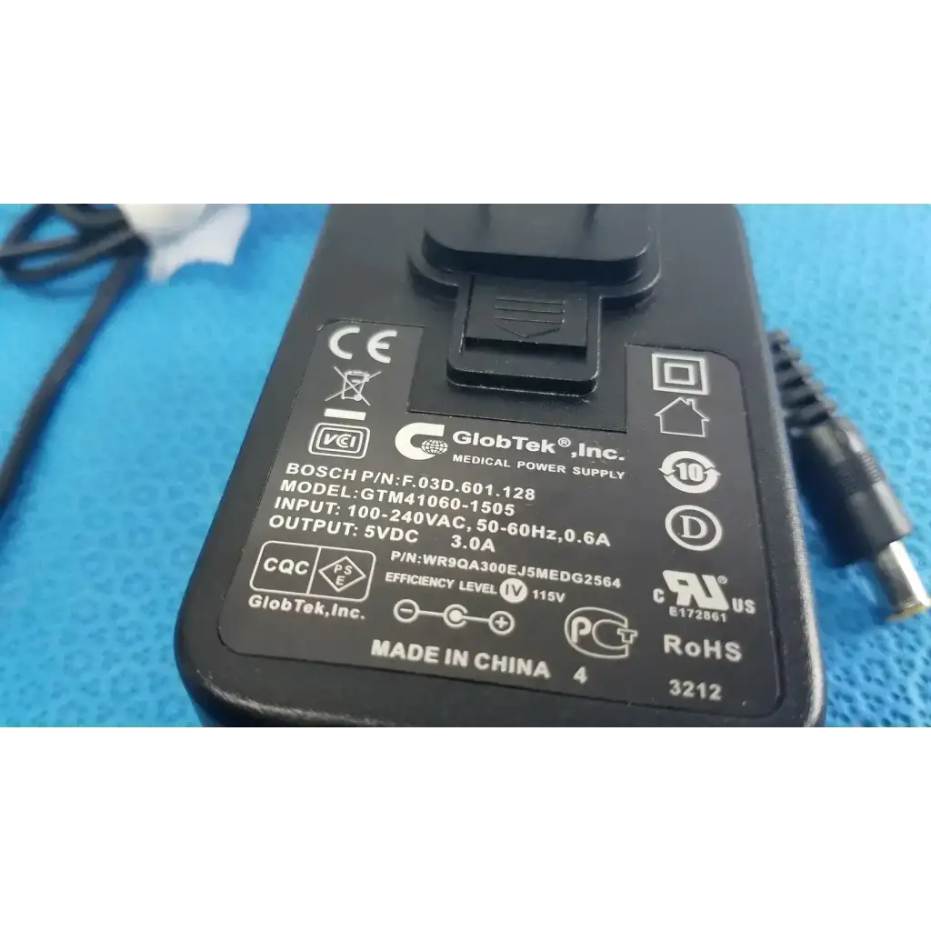 Black plastic globtek gtm41060-1505 medical power supply adapter with metallic connector and printed specifications