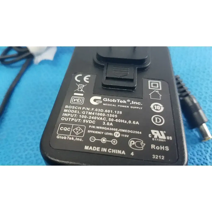 Black plastic globtek gtm41060-1505 medical power supply adapter with metallic connector and printed specifications