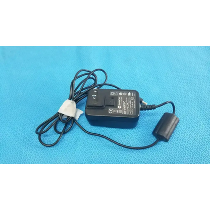 Black plastic Globtek GTM41060-1505 medical power supply with coiled cable and white band securing cord