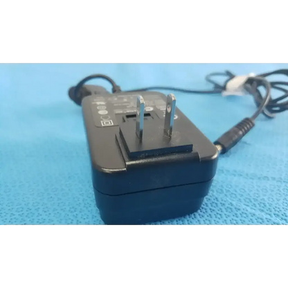 Black plastic globtek GTM41060-1505 medical power supply with silver prongs and coiled black power cord for medical power