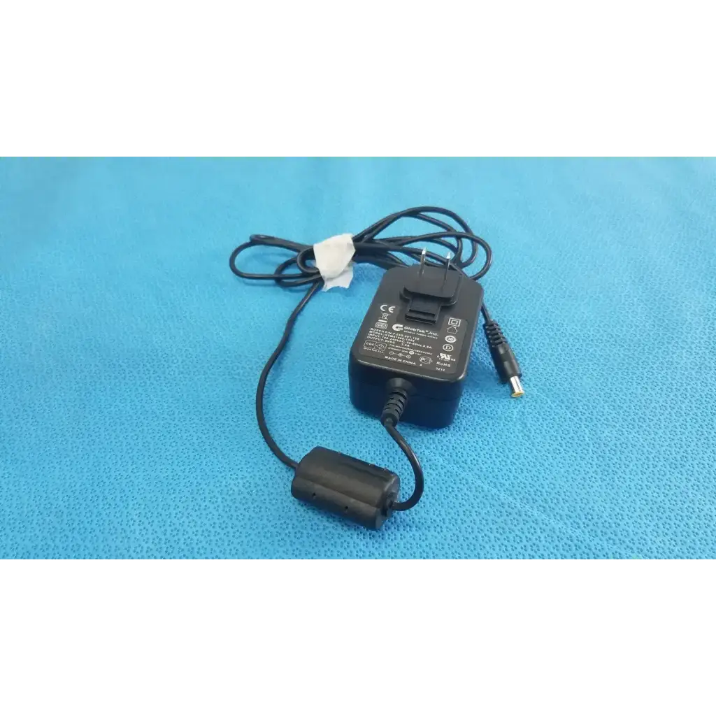 Black plastic globtek GTM41060-1505 medical power supply with coiled cord and cylindrical power connector