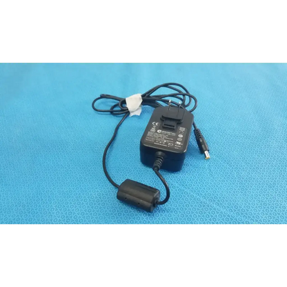 Black plastic globtek GTM41060-1505 medical power supply with coiled cord and cylindrical power connector