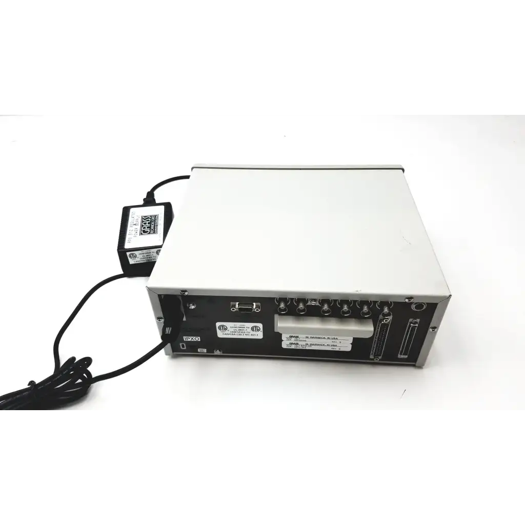 Silver and black grass 15lt physiodata amplifier system with multiple ports and connected power supply at the back side