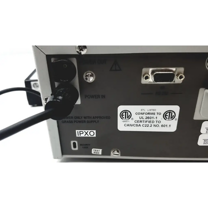 Back side of silver metallic grass 15lt physiodata amplifier system with black power input and db9 serial port labels