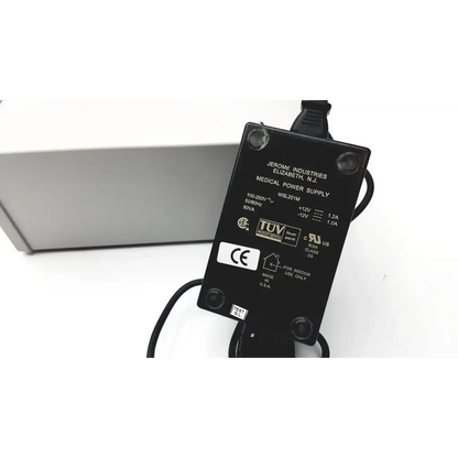Black rectangular medical power supply adapter with specifications labels on the back for grass 15lt physiodata amplifier system