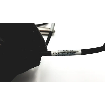Black hand held ws137872 scanteam barcode scanner cable with white label wrapped around it