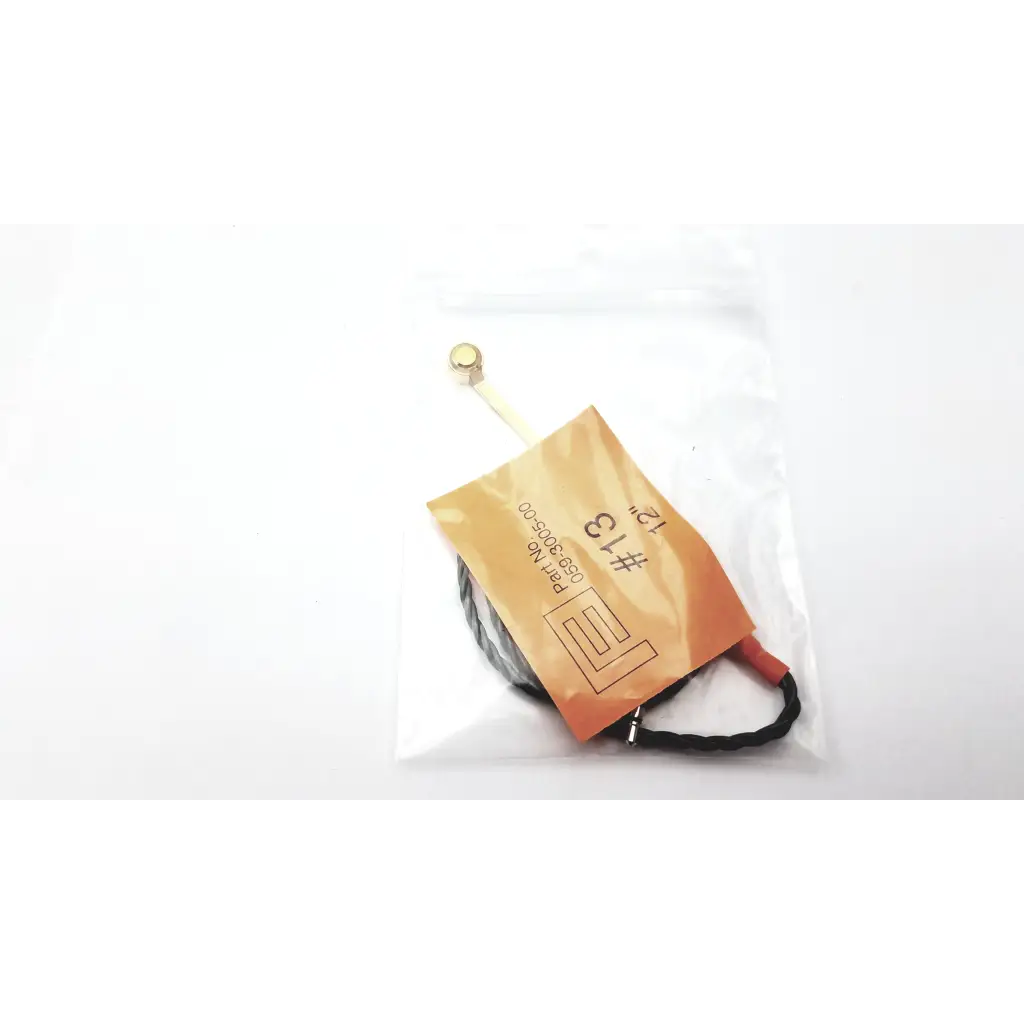 Black coiled hearing aid programming adapter with gold connector and orange label marked 13 for hearing aid use