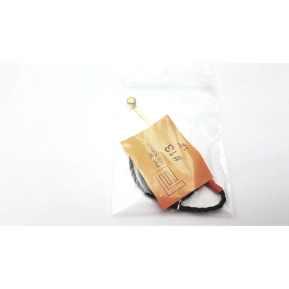 Black coiled hearing aid programming adapter with gold connector and orange label marked 13 for hearing aid use