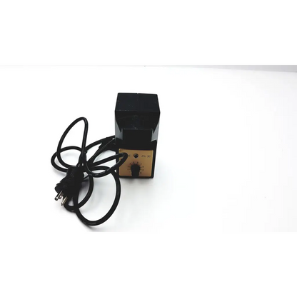Black rectangular electric heater with gold control panel and power cord for heine en30 power supply