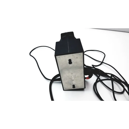 Black rectangular heine omega 180 ophthalmoscope wired battery supply with metallic back panel and coiled cables