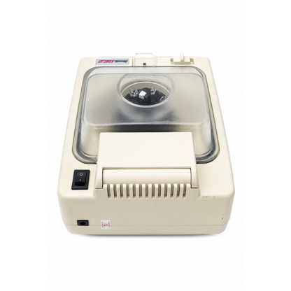 Cream-colored desktop microtome with transparent lid and black control panel in biomed certified hematastat-ii centrifuge medical equipment