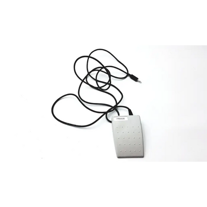 Silver rectangular matte foot pedal with circular indentations and black coiled cable for herga electric chair leg control