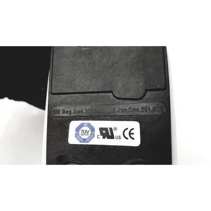 Black plastic herga electric chair leg control with white label showing tuv ul and ce certification marks on back side