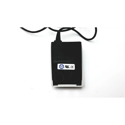 Black rectangular usb charging adapter with white plastic casing and black power cord for herga electric chair leg control