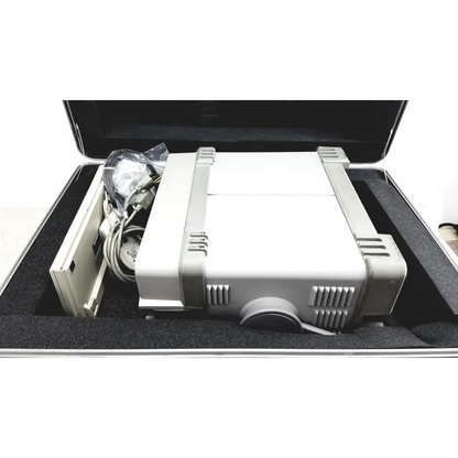 Gray and white fujifilm projector with ventilation grilles shown with hewlett packard optical time domain reflectometer and case