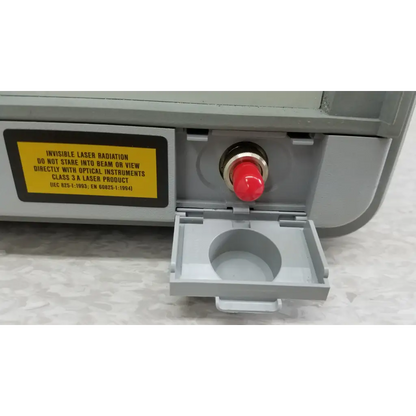 Gray hewlett packard 8147 optical time domain reflectometer with red button and yellow warning label in case