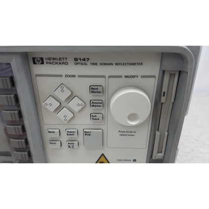 Gray hewlett packard 8147 optical time domain reflectometer with white control panel and rotary knob for precise testing