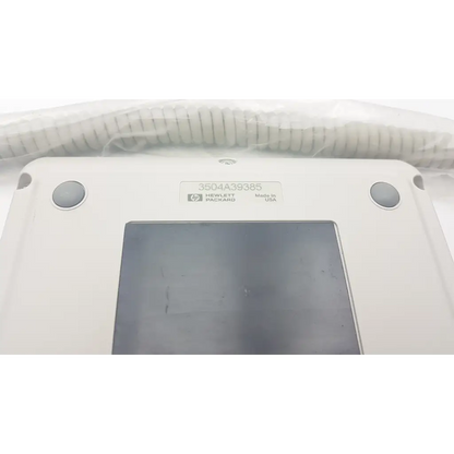 White hewlett packard m1106c patient monitor keyboard with matte finish and coiled cable on top