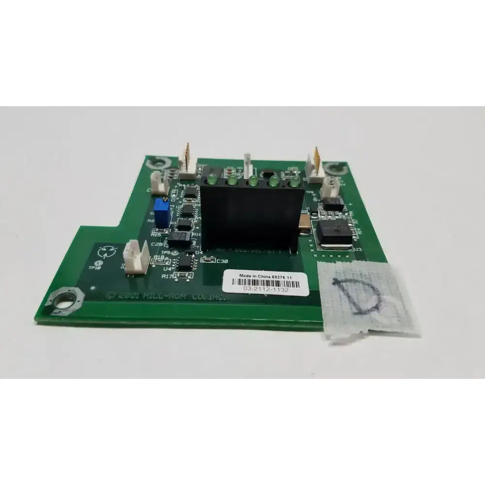 Green printed circuit board with black rectangular component and various electronic parts in hill-rom 2001 light relay control mother board