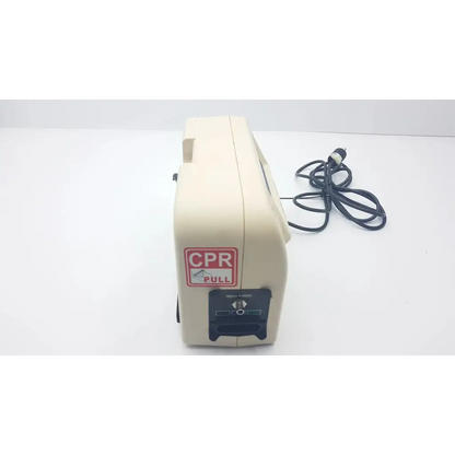 Beige cpr training manikin with red and white cpr pull label next to hill-rom mdq-79r0 synergy air elite air mattress pump