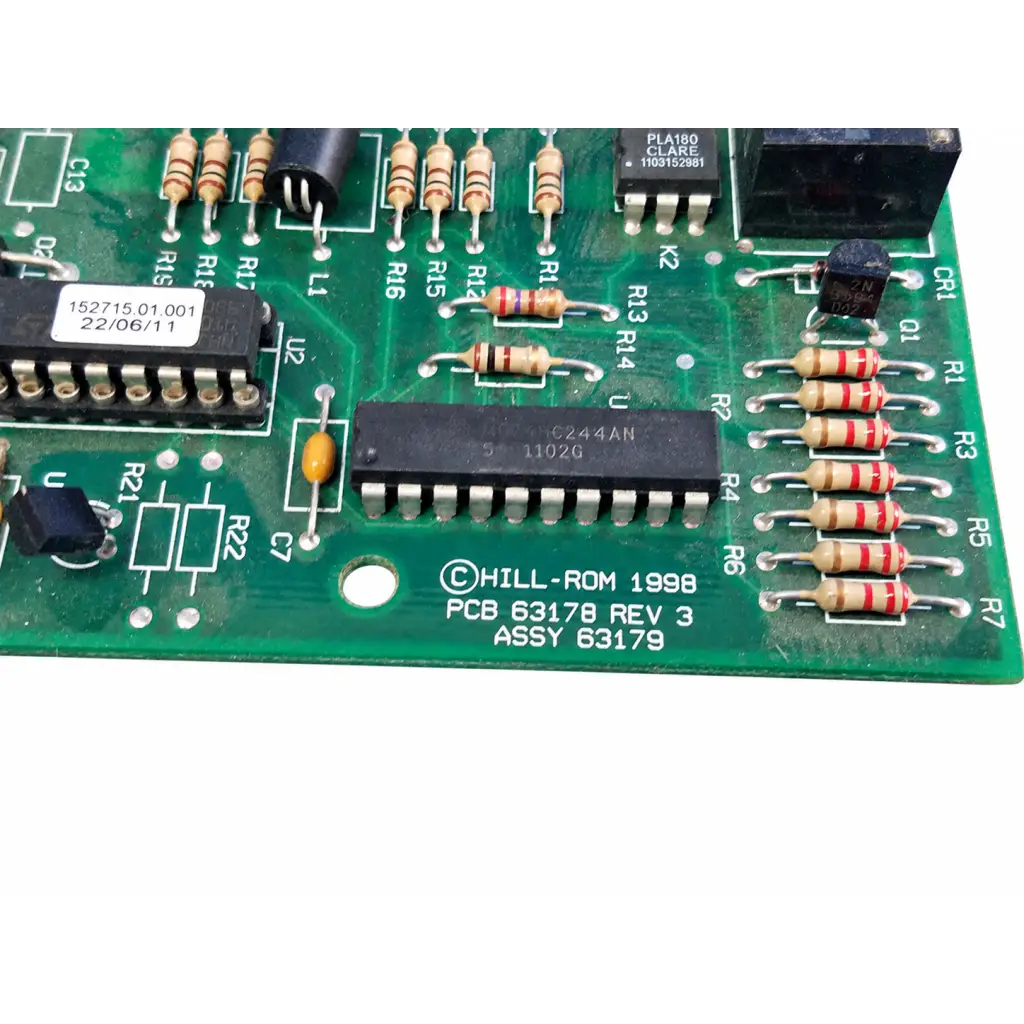 Green printed circuit board with black integrated circuits beige resistors and hill rom 1998 label total care control board assembly