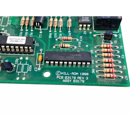Green printed circuit board with black integrated circuits beige resistors and hill rom 1998 label total care control board assembly
