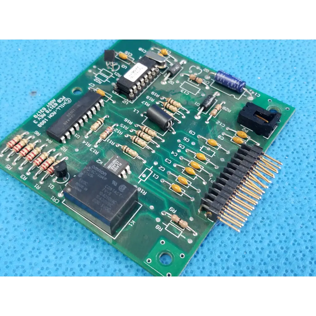 Green printed circuit board with black integrated circuits and connectors for hill rom total care control board assembly