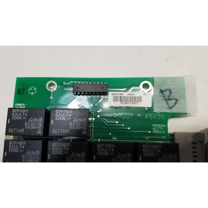 Green omron g5le-14 relay module with black rectangular relays and white barcode label on hill rom total care ent light control board