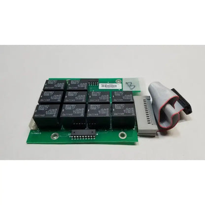 Green printed circuit control board with black omron relays and gray connector cable for hill rom total ent light use