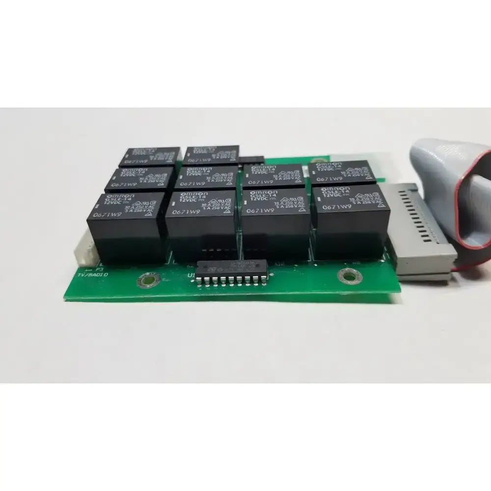Green circuit board with black omron relays and gray connector in hill rom total care ent light relay control board assy