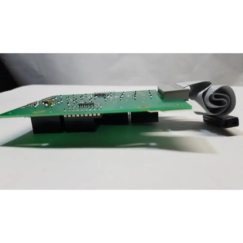 Green hill rom total care sidecomm ent light control board with black components and coiled gray ribbon cable