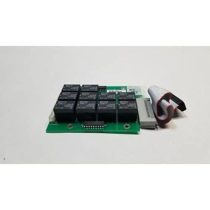 Green hill rom total care control board with black relay modules and gray connector cable for ent light system