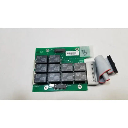 Green printed circuit control board with black relay modules and gray ribbon cable for hill rom total ent light use
