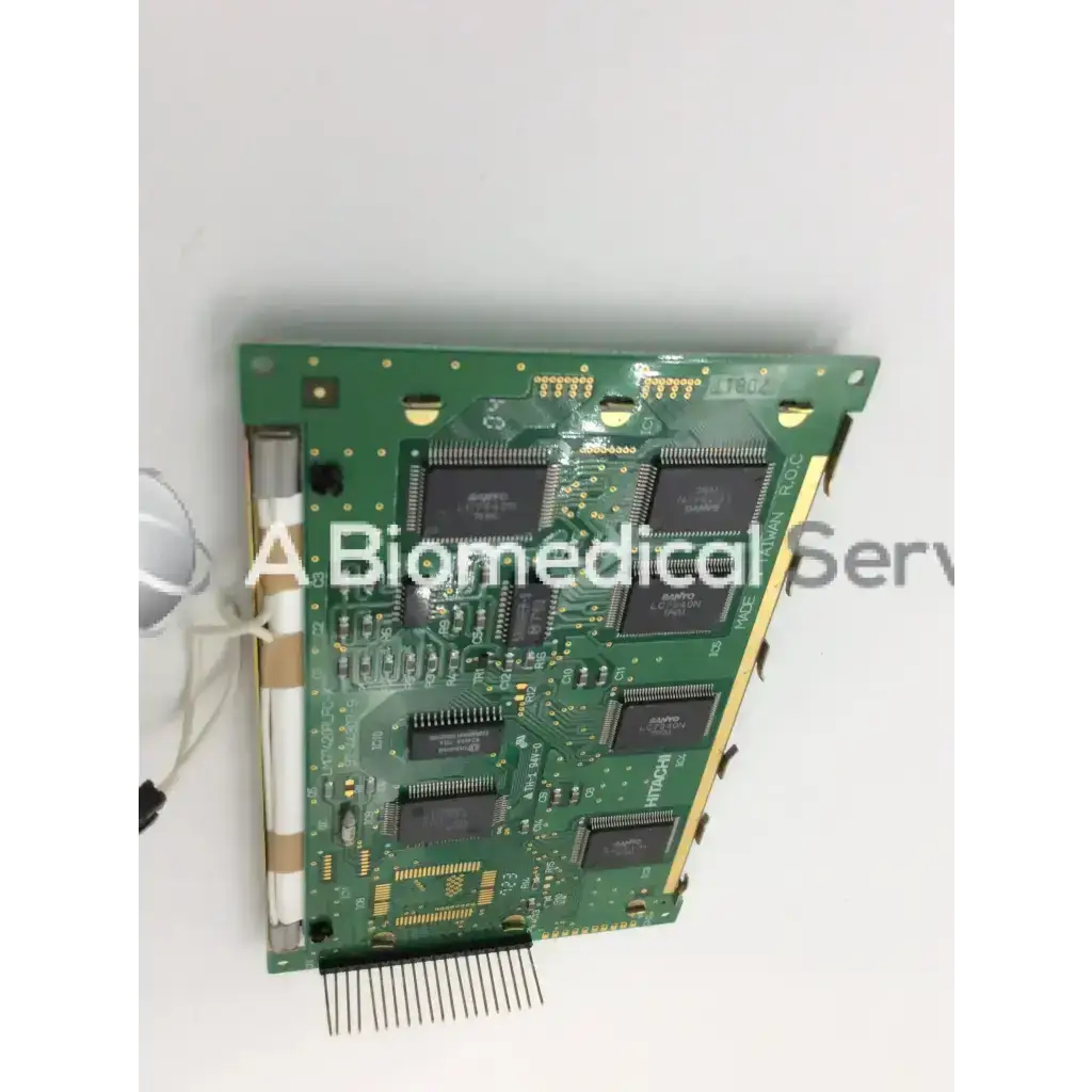 Green circuit board with black integrated circuits and gold connectors on back side of hitachi lcd screen display panel