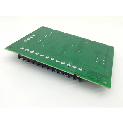 Green rectangular sa4208sn-1 alarm universal expander board with silver solder pads and black heat sinks along one edge