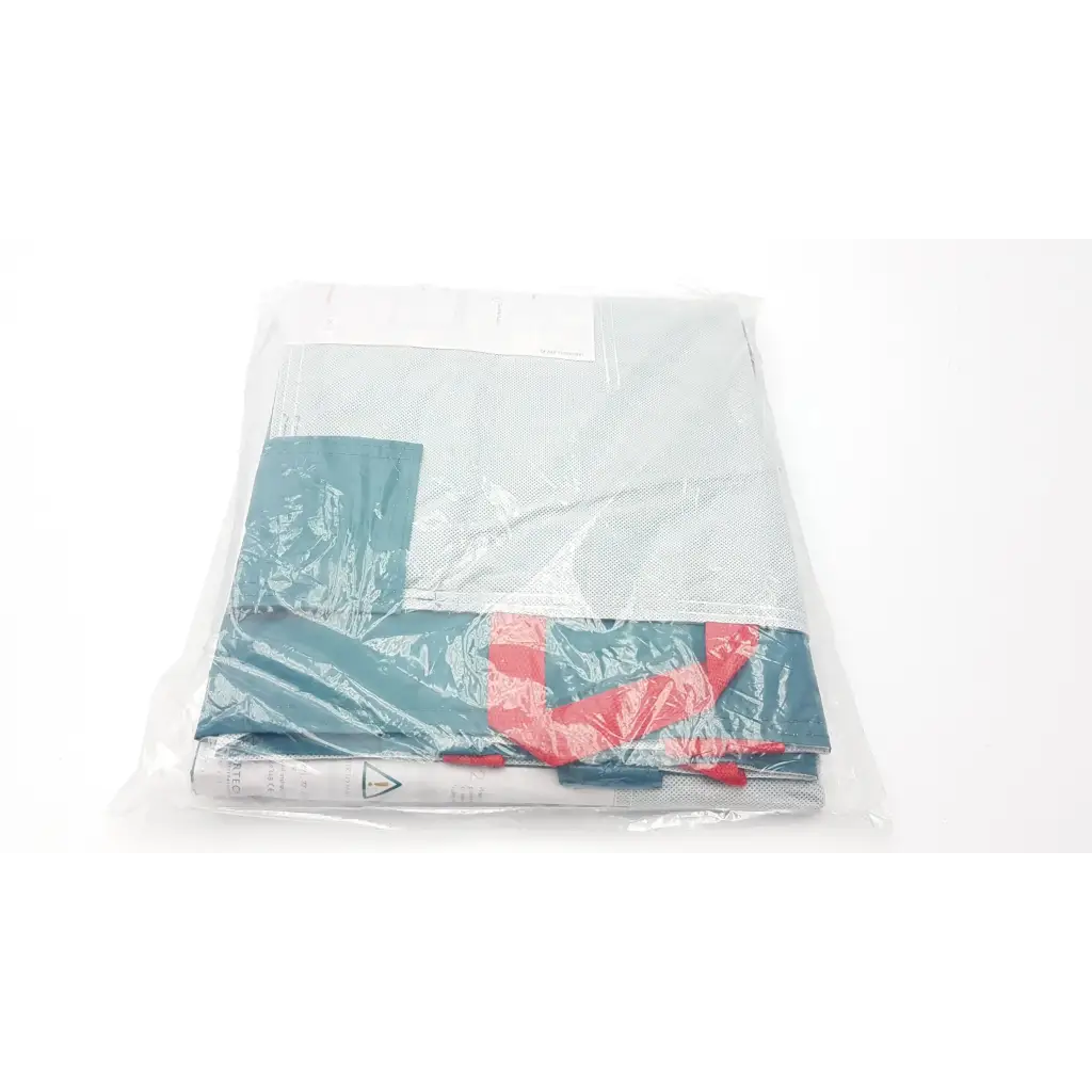 Teal and red patterned fabric lateral transfer air mattress wrapped in clear plastic for single-patient use