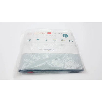 A light gray fabric lateral transfer air mattress foot end cover in clear packaging with hovermat label and product details